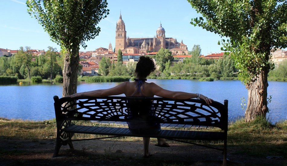 woman on a bench in a picturesque park