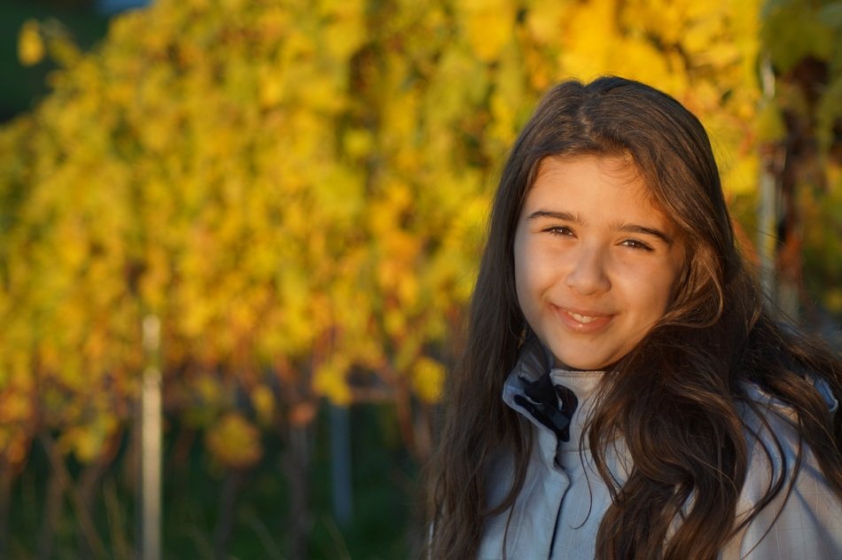 little girl on a background of autumn trees