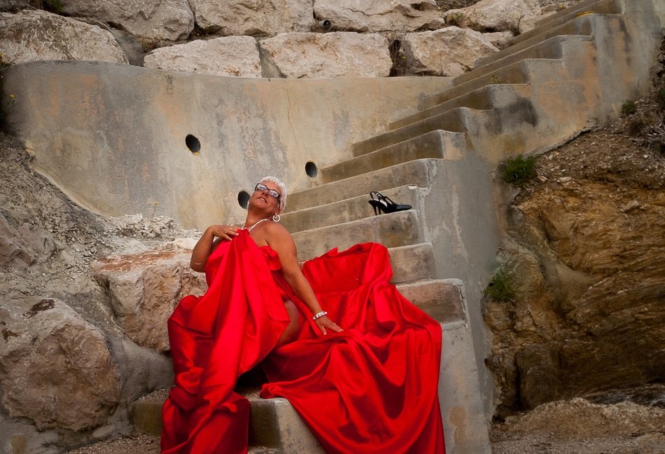 woman in a red dress on the stairs in Assisi, Italy