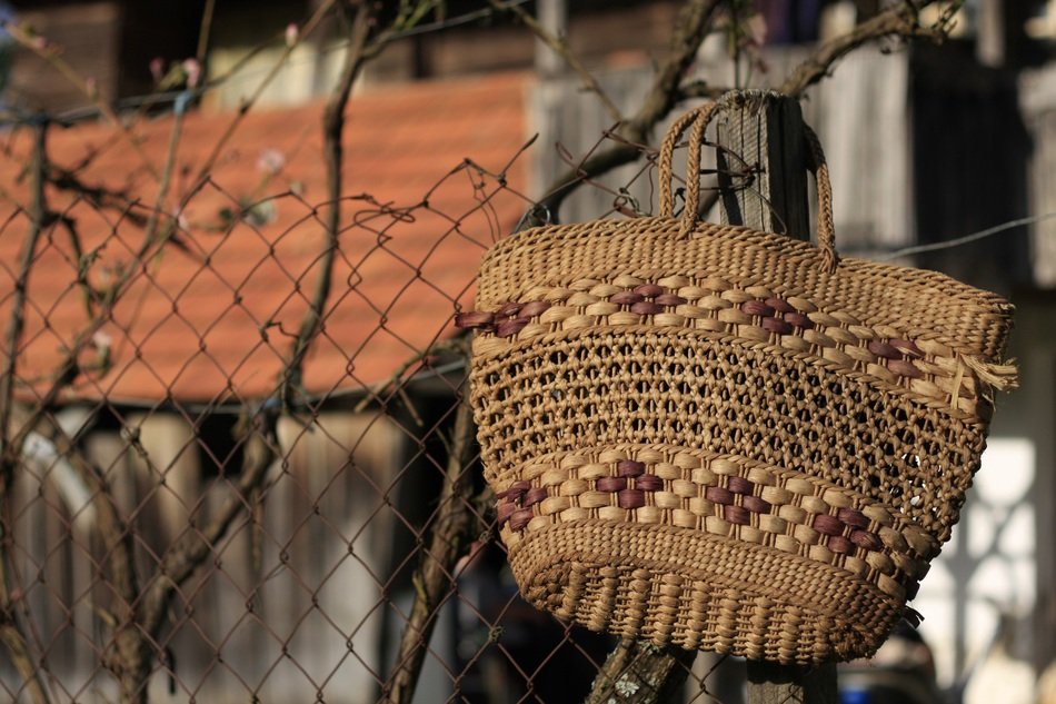 old fashioned knitted bag on wood