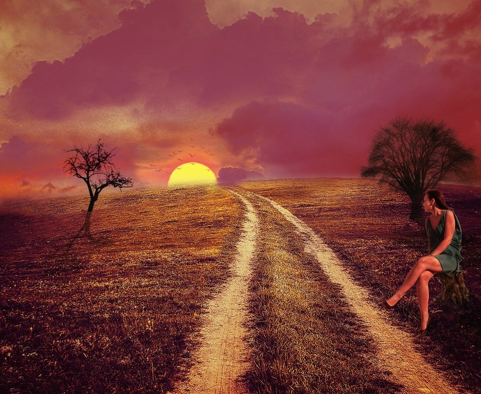 woman near the road at sunset
