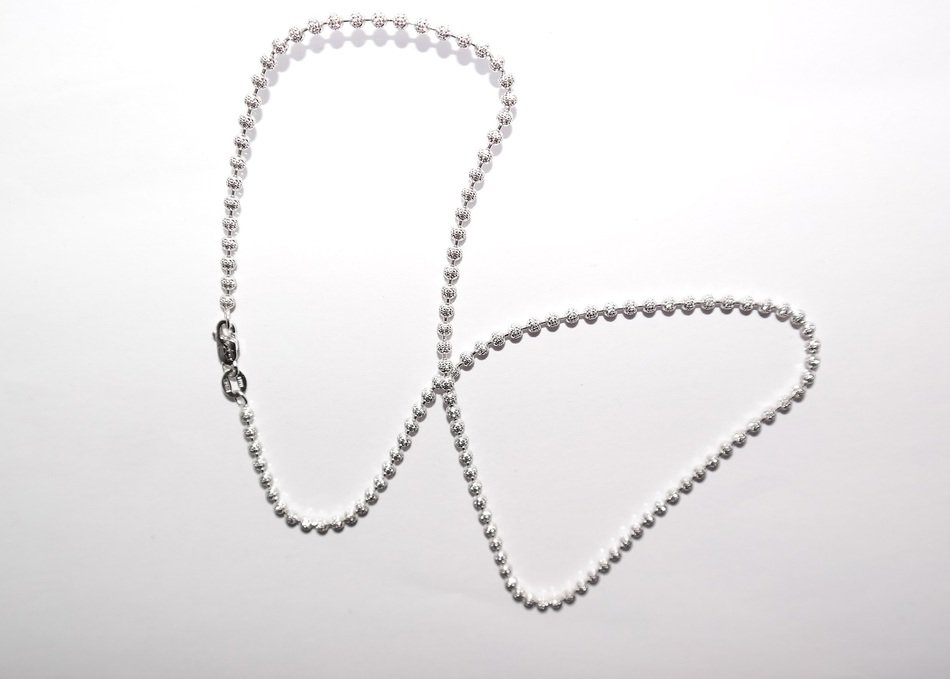 silver chain on a white surface