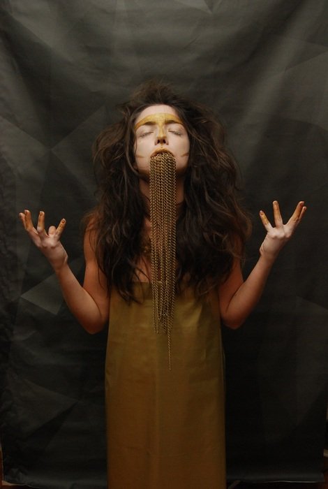 girl in a gold dress with a beard