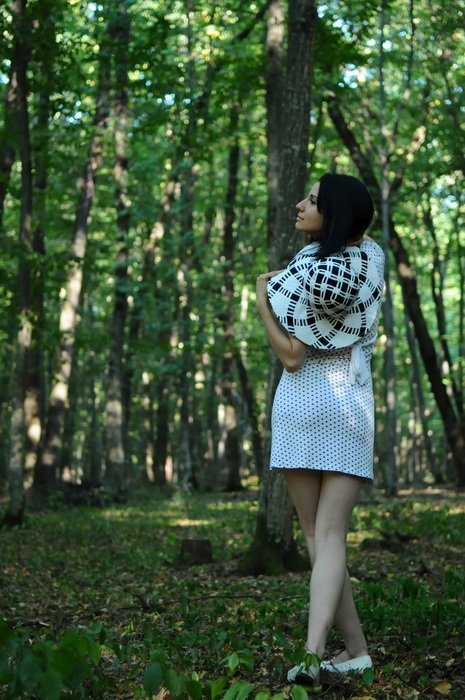 charming young woman in the forest