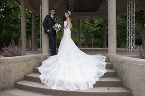 bride and groom posing on the stairs