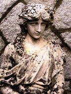 stone statue of a woman near the wall
