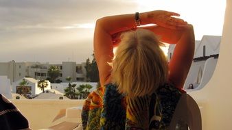 blonde Woman looking at sun, back view, spain, Canary Islands, Lanzarote