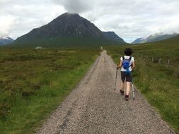 woman climbs uphill along the trail