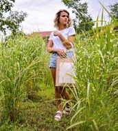 walking girl in a field in summer