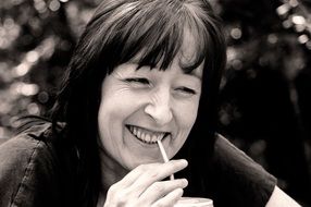 senior woman drinking a cocktail, black and white