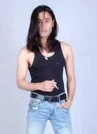 young man with long hair in a t-shirt and jeans