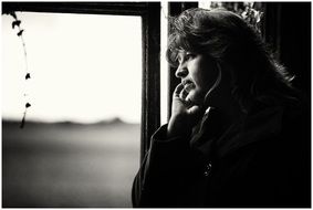 Loneliness, Woman at window