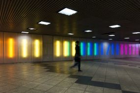 silhouette of walking woman in colorful illuminated interior