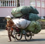 man with rubbish on a bicycle in vietnam