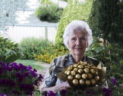 portrait of old woman with Chocolate Bouquet