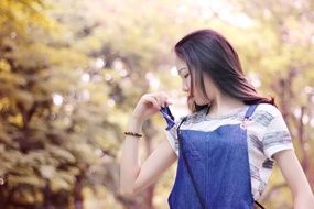 walking young woman in summer park