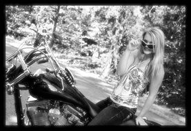 black and white photo of a girl on a motorcycle