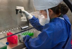 microbiologist with a pipette in the laboratory