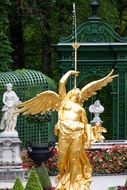 gilded woman sculpture in the park of linderhof palace