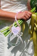 horseshoe form Wedding tags on hand of Bride