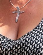 decoration in the form of a cross on the neck of a woman