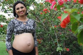 woman waiting for baby posing in the garden