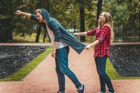 young couple posing in a park