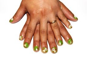 hands with green artistic manicure