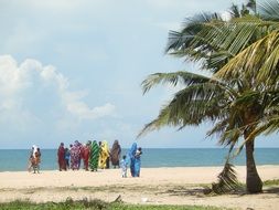 a group of women in colorful clothes on the beach