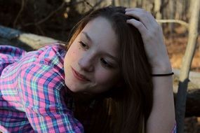 Portrait of happy girl in autumnal forest