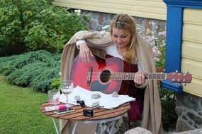 girl playing guitar at the table