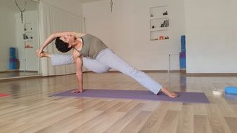 young Woman doing Yoga poses indoors