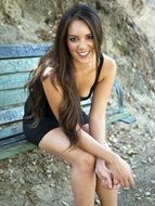 attractive young woman sitting on the bench