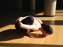 girl in a yoga pose on the floor