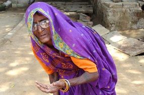 beggar indian woman in purple dress