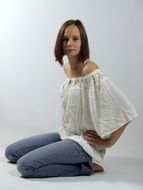 girl sitting near the white wall