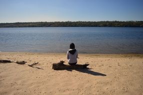 Woman sitting on a sand