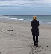 Woman is walking on the beach