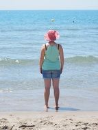 woman in a wide hat on a sunny beach