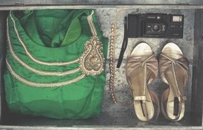 green dress, golden boots and camera