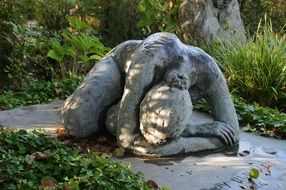 woman suffering stone sculpture