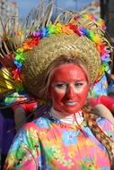 masked woman in hat at carnival