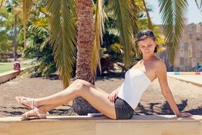 girl on the background of palm trees on vacation