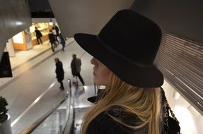 caucasian woman in black Hat in Shopping Center