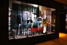 sale, mannequins in a showcase in night lighting