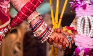 hands of the bride and groom at an indian ceremony