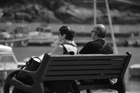 couple of seniors on a bench in black and white background