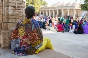 traditional dressed Indian woman sits at Temple