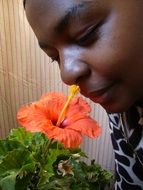 African American woman with a bright flower