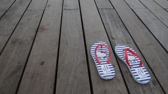 beach slippers on the plank floor